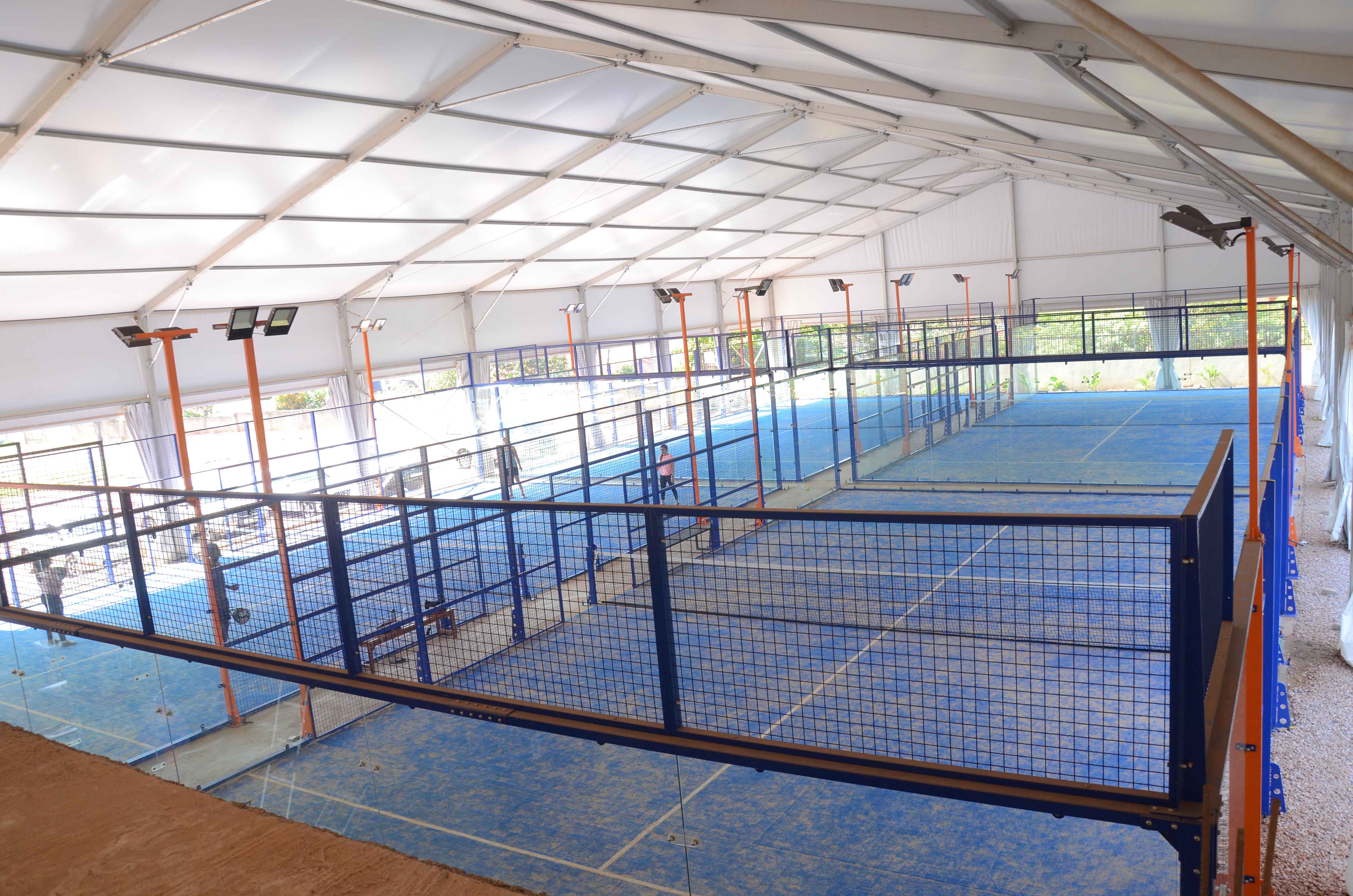 Covered blue padel courts; illustrative sporting photograph, location not verified as Spain
